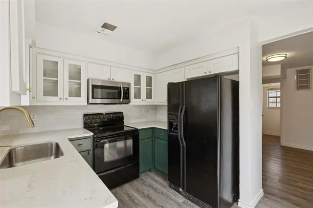a kitchen with a refrigerator stove and sink