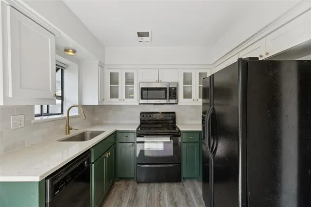a kitchen with a refrigerator sink and stainless steel appliances