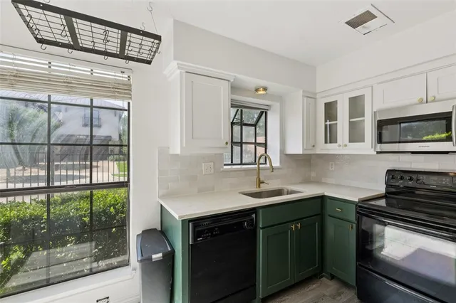 a kitchen with a sink and large window