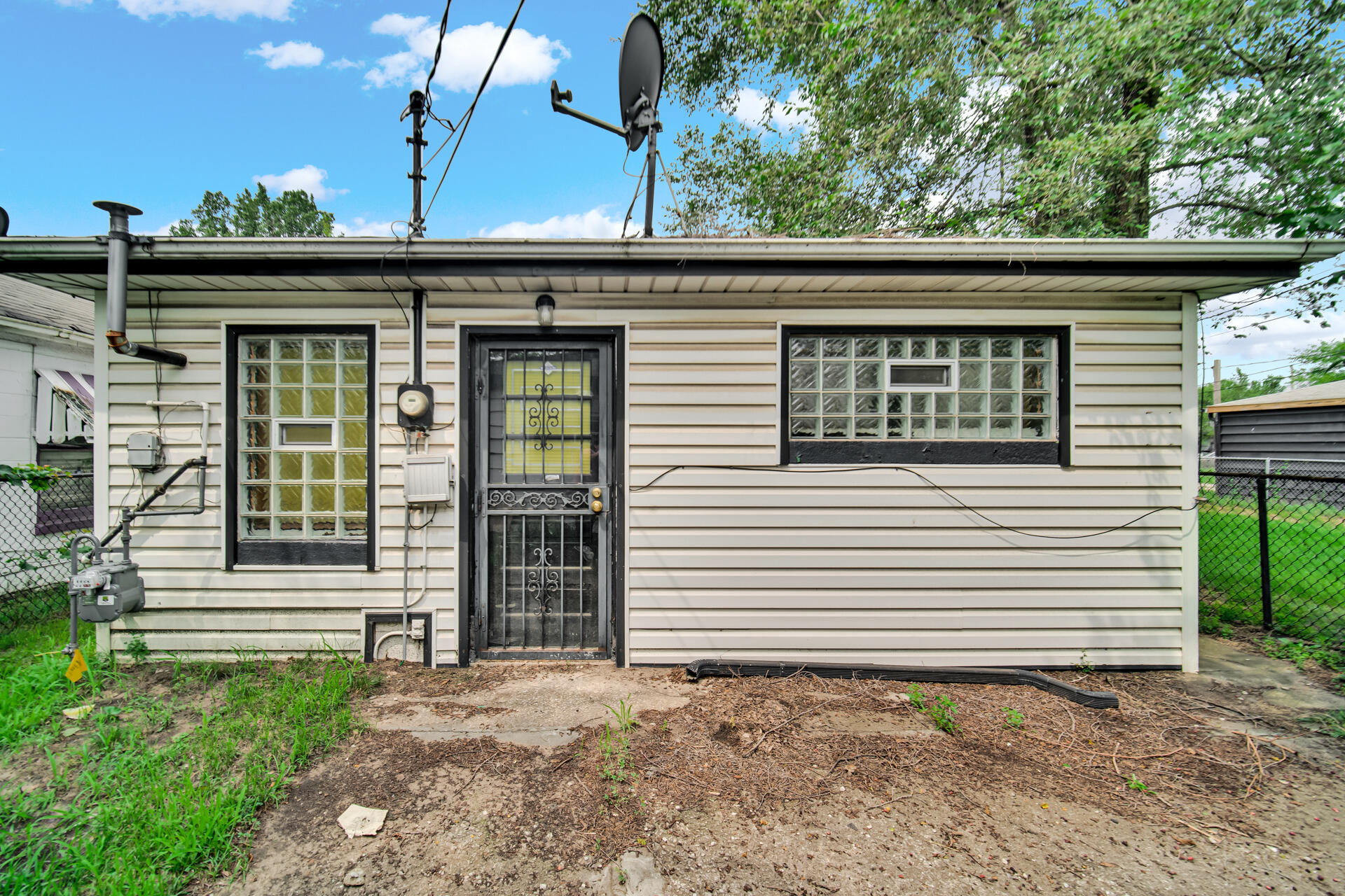 2425 Prospect Street Gary, IN 46407 - Photo 4 of 4 a view of a house with a small yard and plants