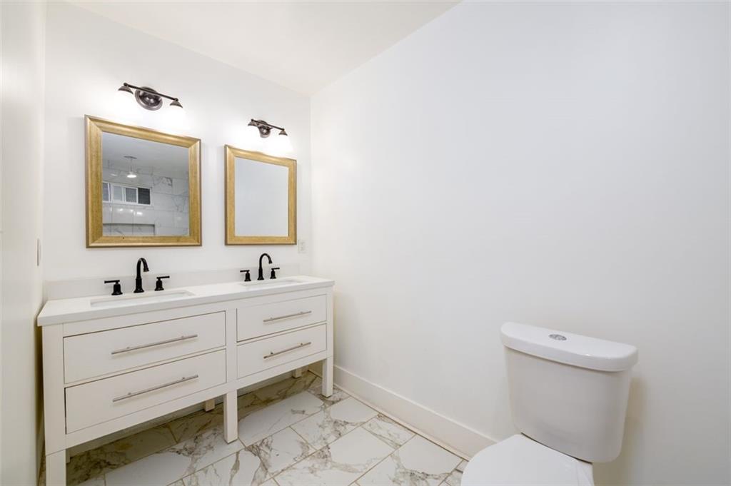 1285 Avon Avenue Southwest Atlanta, GA 30310 - Photo 15 of 28 a bathroom with a toilet sink and mirror
