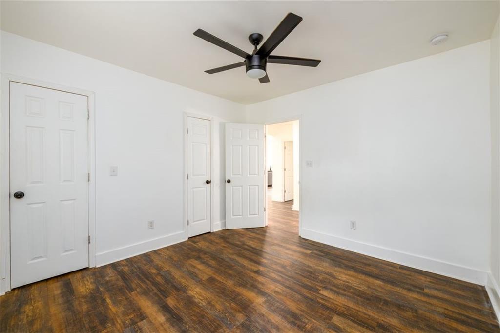 1285 Avon Avenue Southwest Atlanta, GA 30310 - Photo 20 of 28 an empty room with wooden floor and ceiling fan