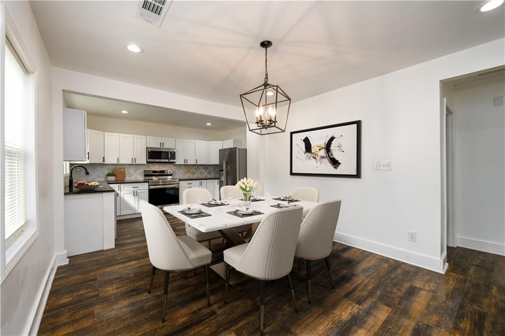 1285 Avon Avenue Southwest Atlanta, GA 30310 - Photo 6 of 28 a view of a dining room with furniture wooden floor and chandelier