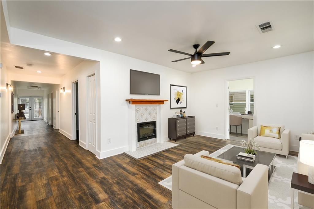 1285 Avon Avenue Southwest Atlanta, GA 30310 - Photo 7 of 28 a living room with furniture a fireplace and a flat screen tv
