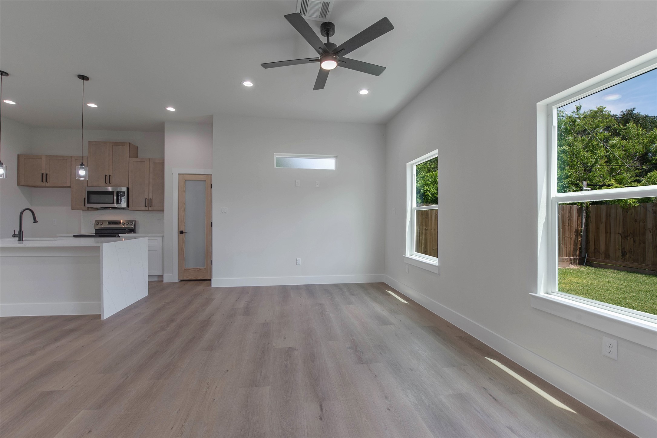 9311 Jutland Road Houston, TX 77033 - Photo 2 of 28 Expansive windows fill the home with natural light, while the no-carpet design and lovely fixtures add a clean, elevated feel throughout.