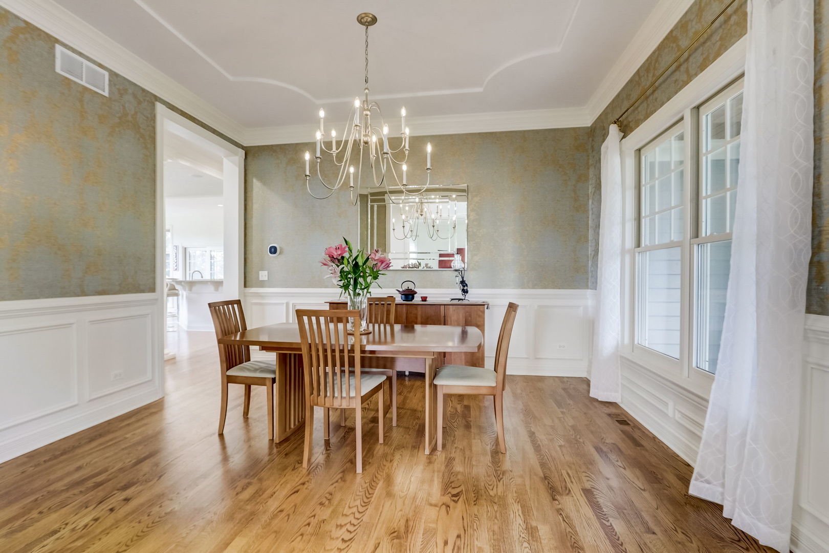 3462 Wild Prairie Lane Geneva, IL 60134 - Photo 6 of 59 a view of a dining room with furniture a chandelier and wooden floor
