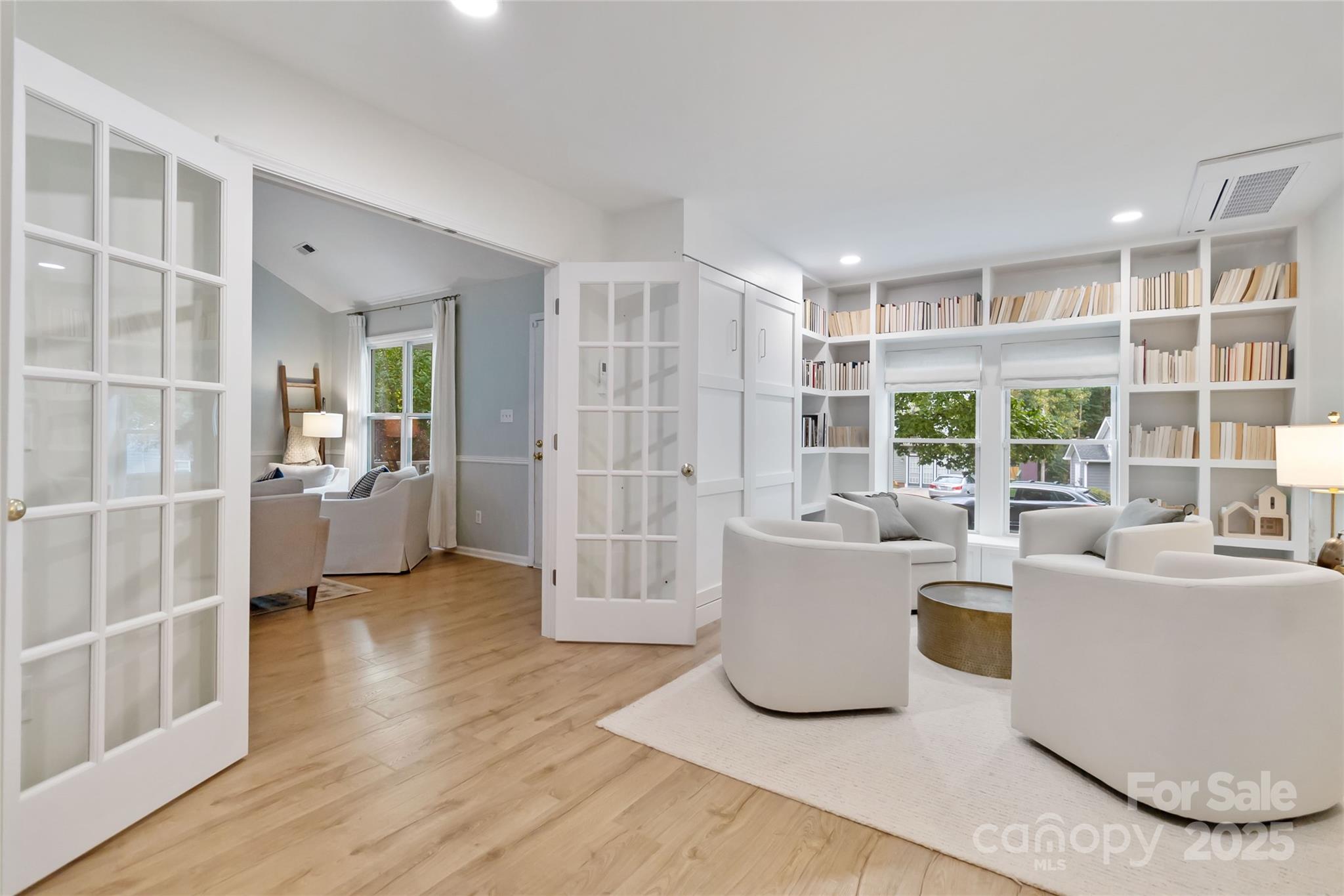 3329 Fortis Lane Matthews, NC 28105 - Photo 14 of 47 a living room with furniture a large window and wooden floor