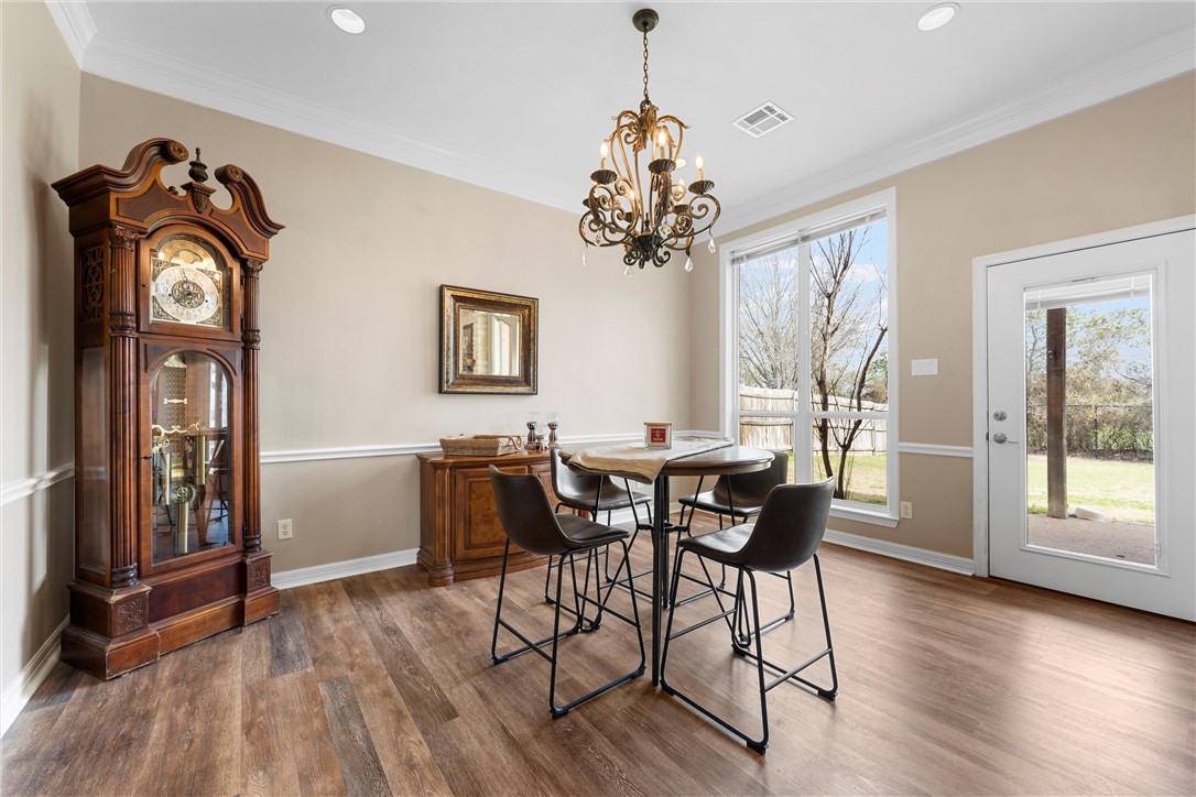 10513 T Bury Lane Waco, TX 76708 - Photo 12 of 36 a view of a dining room with furniture window and wooden floor