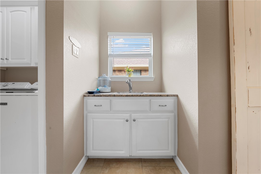 10513 T Bury Lane Waco, TX 76708 - Photo 19 of 36 a view of a sink and a mirror