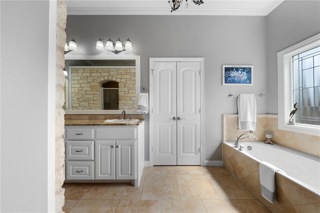 10513 T Bury Lane Waco, TX 76708 - Photo 27 of 36 a spacious bathroom with a double vanity sink and a mirror