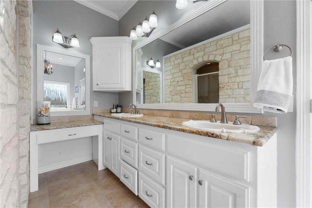 10513 T Bury Lane Waco, TX 76708 - Photo 29 of 36 a bathroom with a granite countertop double sink and a mirror