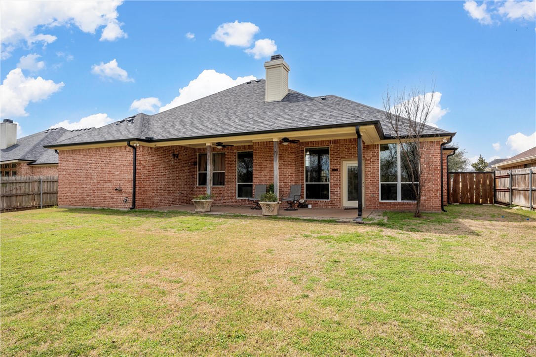 10513 T Bury Lane Waco, TX 76708 - Photo 34 of 36 a view of a house with floor to ceiling windows and a yard