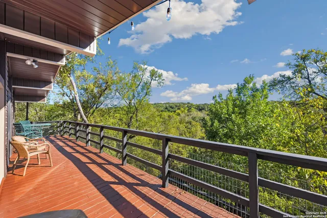 a view of a balcony with wooden floor