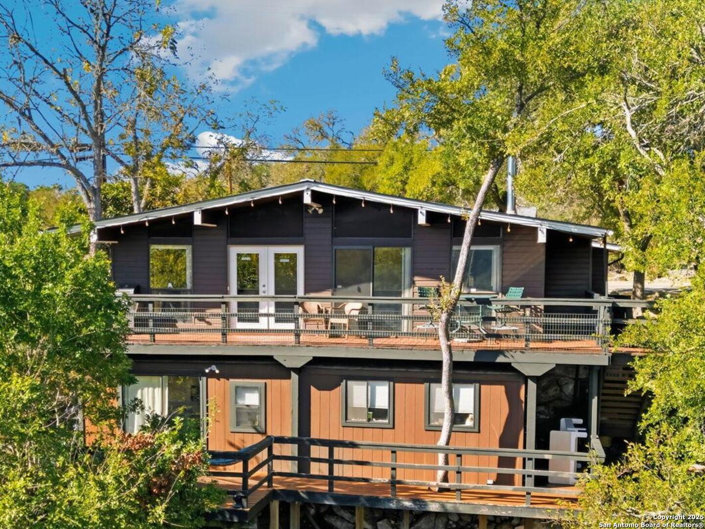 3119 Tanglewood Trail Spring Branch, TX 78070 - Photo 2 of 41 a view of a dinning table and chairs in patio