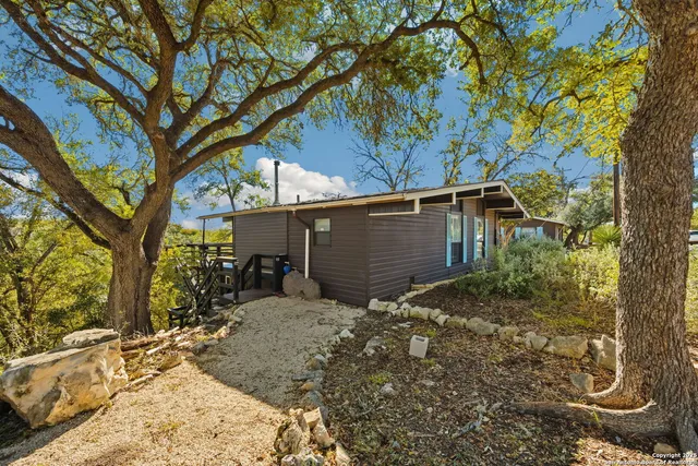 a view of a house with a tree in the background