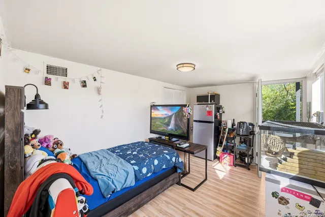 a bedroom with bed and a bookshelf