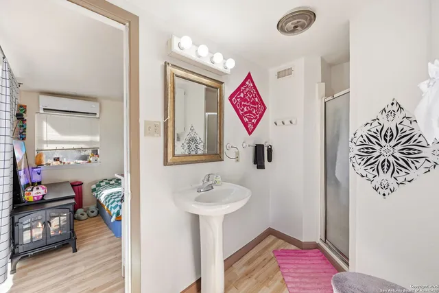 a view of a hallway to a livingroom with furniture