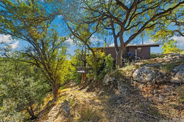 a view of a house with a tree