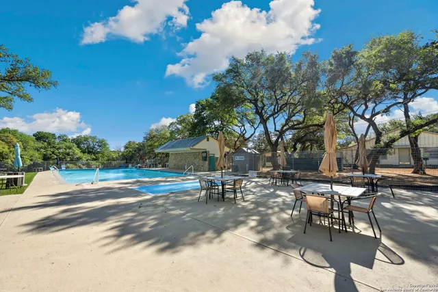 a view of a swimming pool with an outdoor seating
