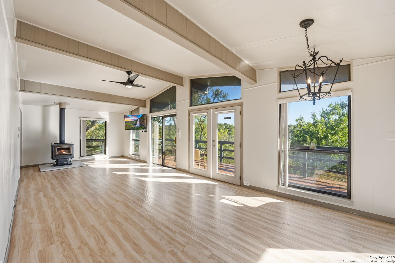 3119 Tanglewood Trail Spring Branch, TX 78070 - Photo 7 of 41 a view of empty room with wooden floor and floor to ceiling window