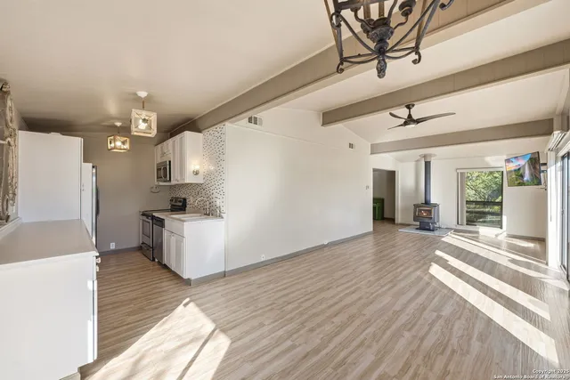 a view of a living room and kitchen with furniture