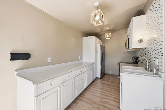 a kitchen with cabinets and window