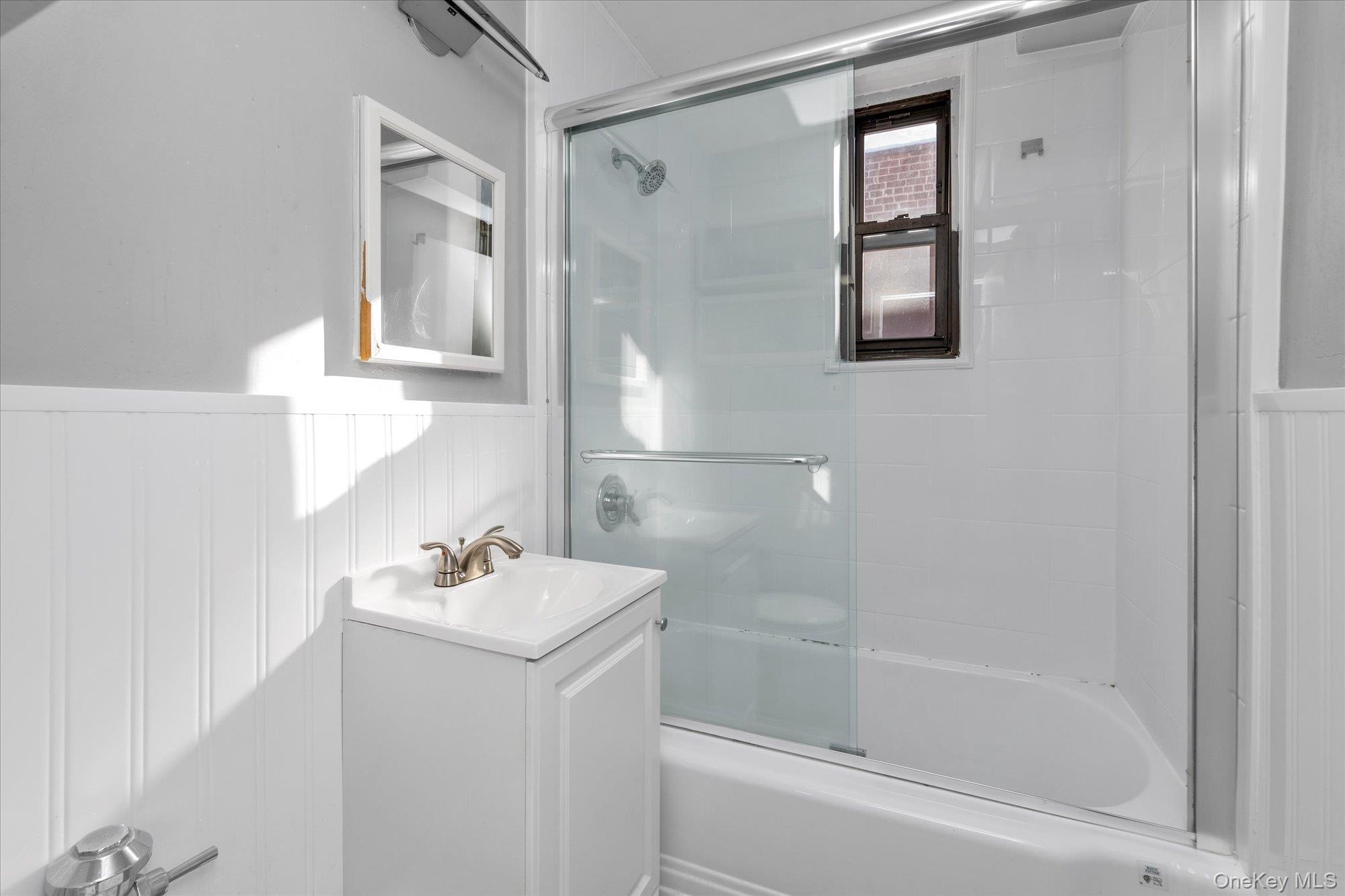 83-40 Austin Street, Unit 7K Queens, NY 11415 - Photo 12 of 19 a bathroom with a sink and a mirror