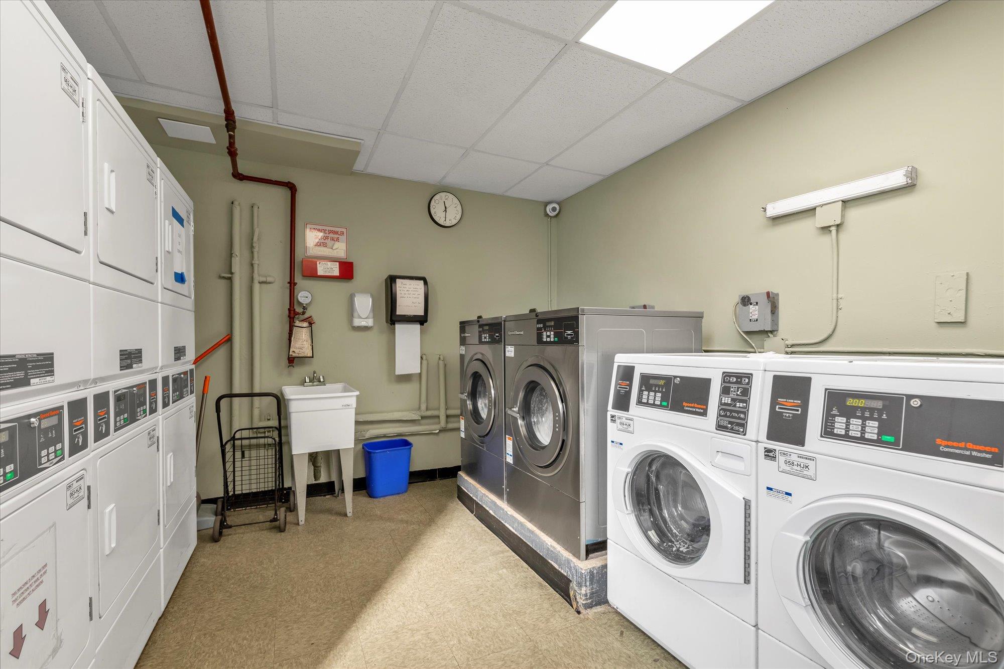 83-40 Austin Street, Unit 7K Queens, NY 11415 - Photo 16 of 19 a utility room with dryer and washer