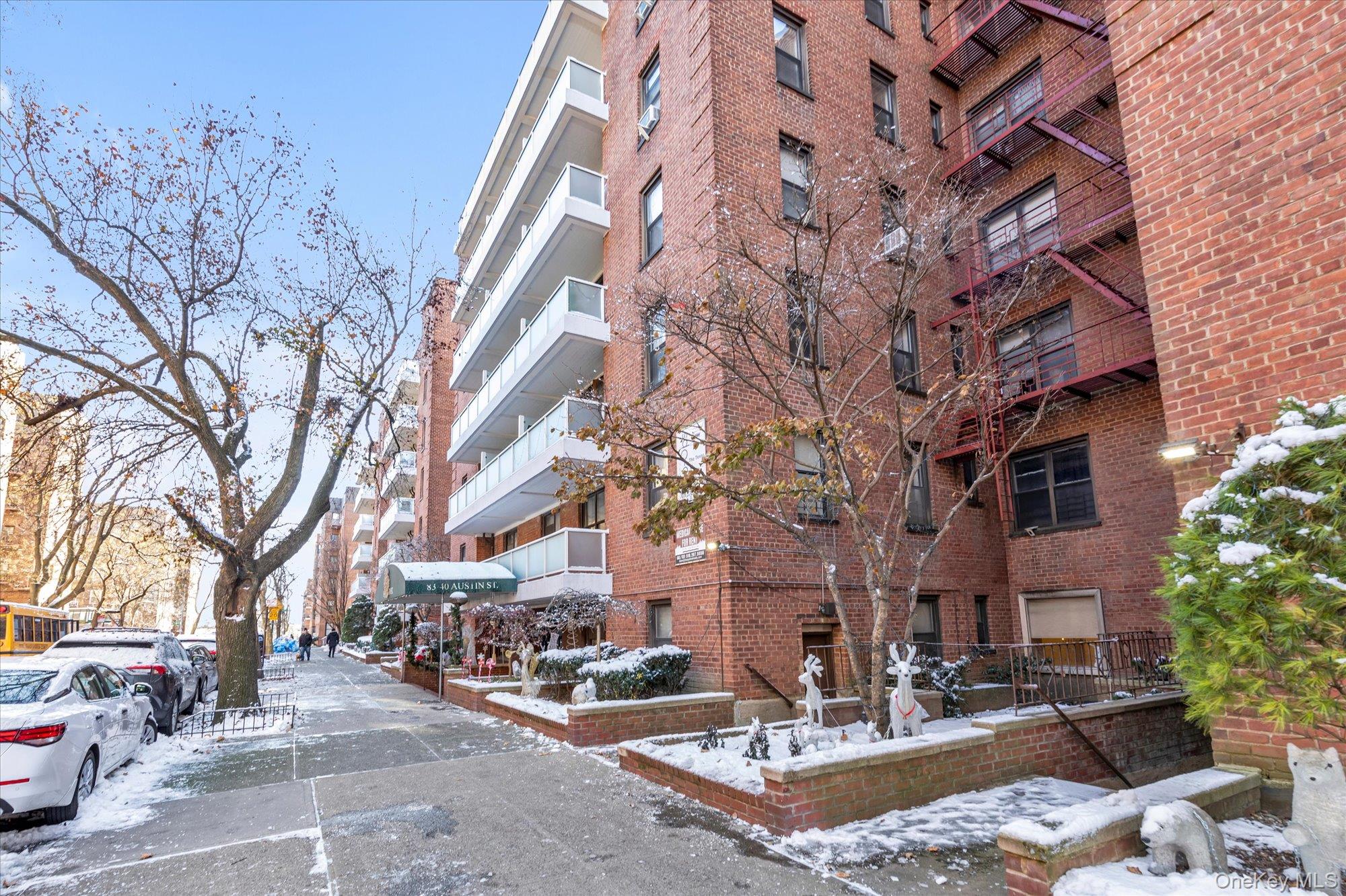 83-40 Austin Street, Unit 7K Queens, NY 11415 - Photo 18 of 19 a building with trees in front of it