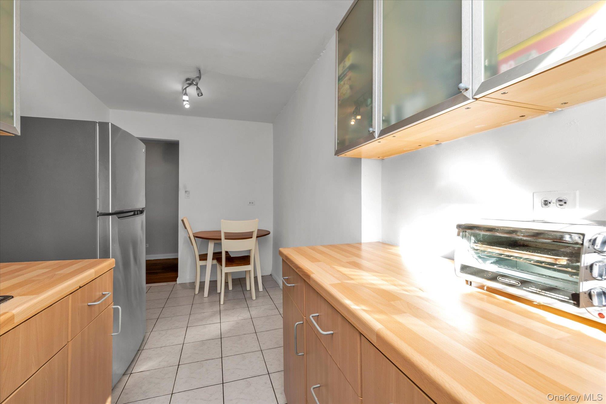 83-40 Austin Street, Unit 7K Queens, NY 11415 - Photo 8 of 19 a kitchen with a sink appliances and cabinets