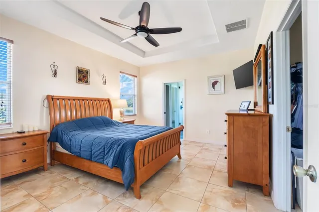 a bedroom with a bed and a ceiling fan