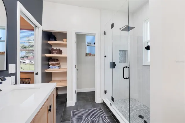 a bathroom with a shower and a sink