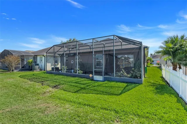 a view of a house with a yard and pathway