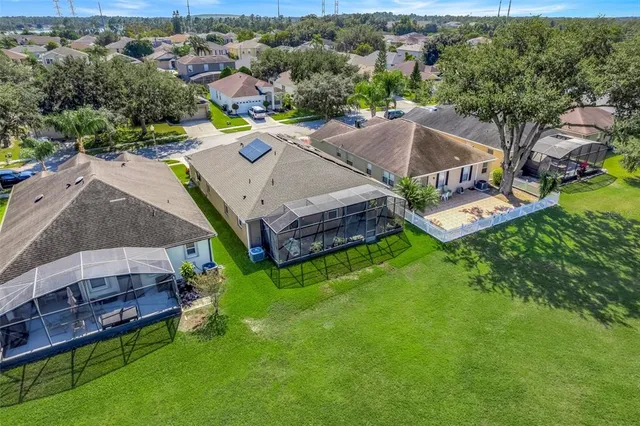 an aerial view of a house with a garden and pool
