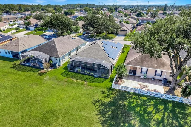 an aerial view of a house with a garden and swimming pool