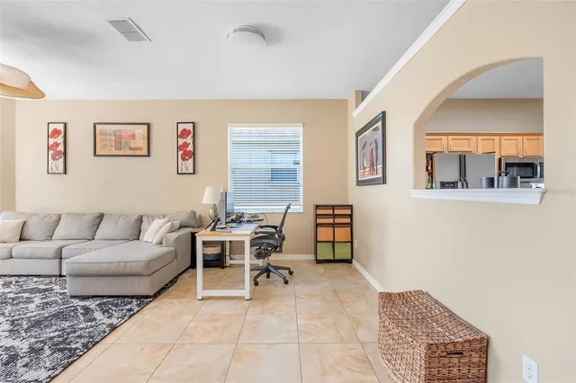 a living room with furniture and a dining table