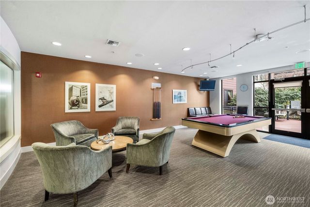 a kitchen with stainless steel appliances a refrigerator a sink a stove a microwave and dining table