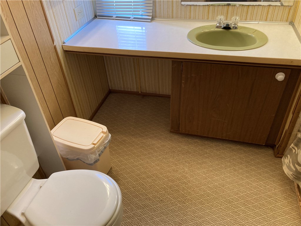 1134 East County Road 2328 Riviera, TX 78379 - Photo 16 of 27 a bathroom with a sink toilet and a mirror