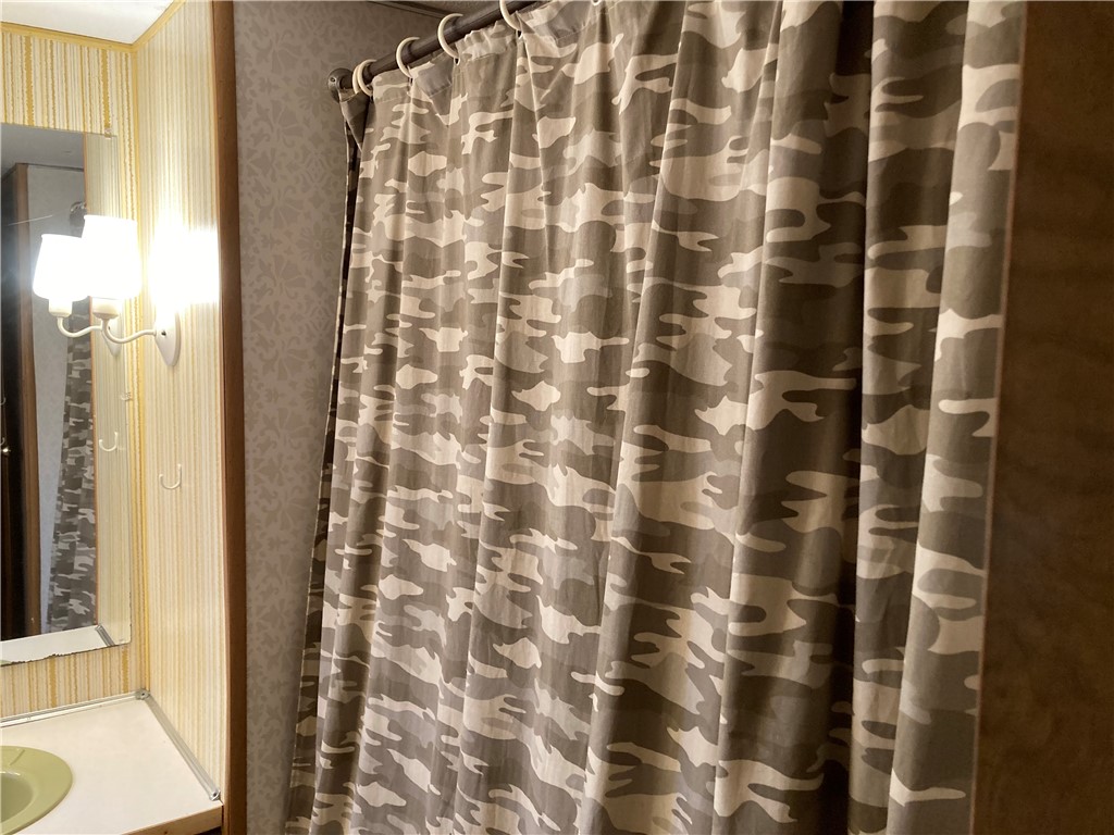 1134 East County Road 2328 Riviera, TX 78379 - Photo 17 of 27 a bathroom with a shower curtain