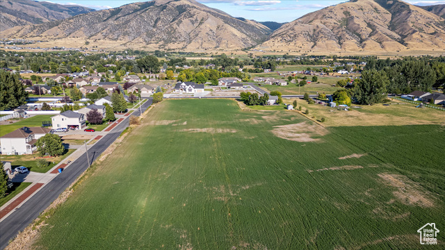 294 West 3400 South, Unit 9 Logan, UT 84321 - Photo 15 of 24 Aerial overview of property's location with a mountainous background and nearby suburban area