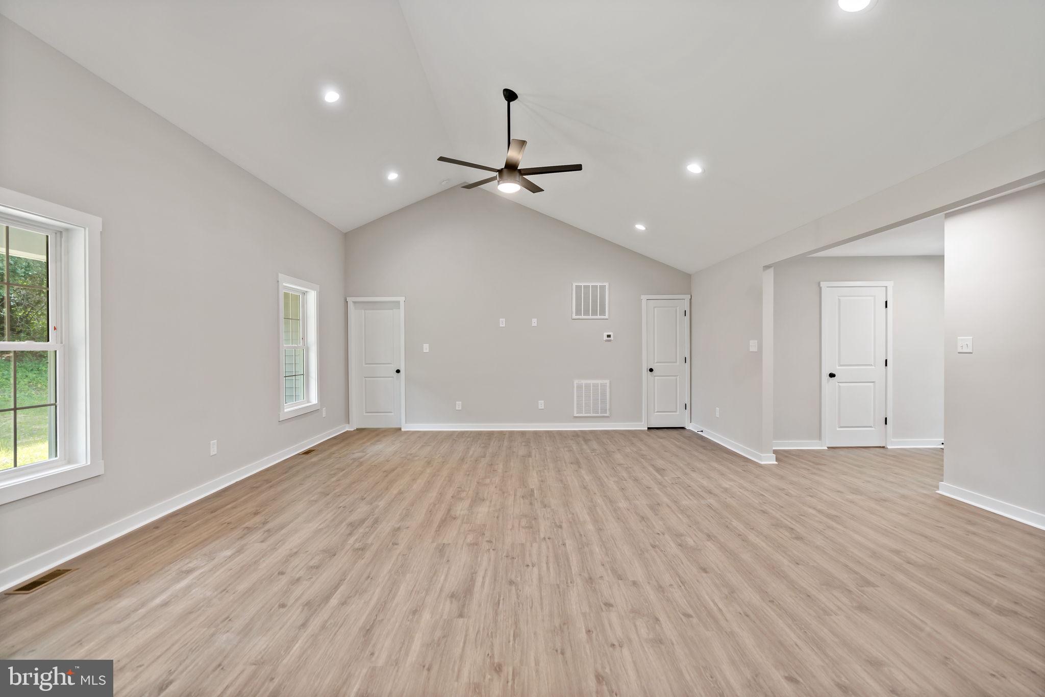 39 Mdg Berkeley Springs Berkeley Springs, WV 25411 - Photo 12 of 46 an empty room with wooden floor ceiling fan and windows