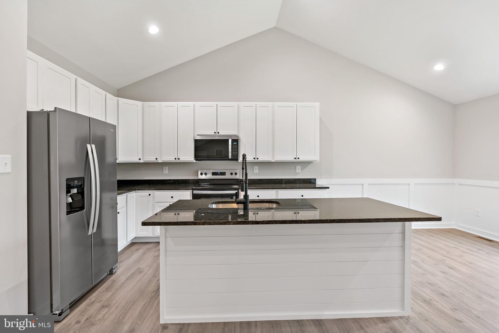 39 Mdg Berkeley Springs Berkeley Springs, WV 25411 - Photo 13 of 46 a kitchen with stainless steel appliances granite countertop a refrigerator a stove a sink and white cabinets