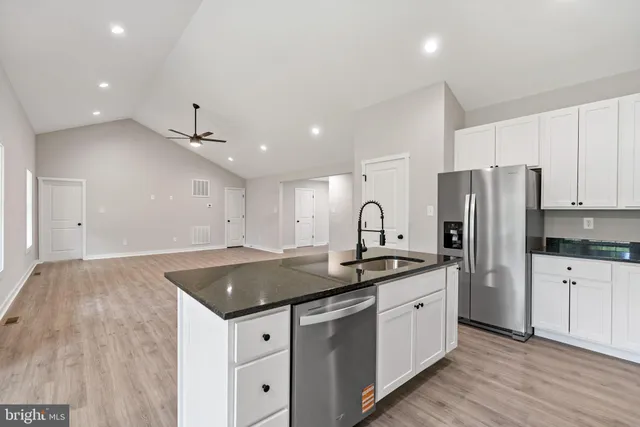 a kitchen with a sink stove and refrigerator