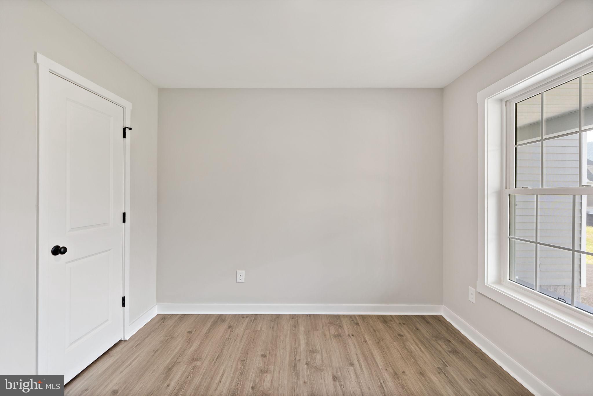 39 Mdg Berkeley Springs Berkeley Springs, WV 25411 - Photo 22 of 46 a view of an empty room with wooden floor and a window