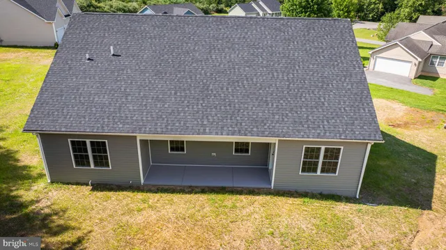 a aerial view of a house with a yard