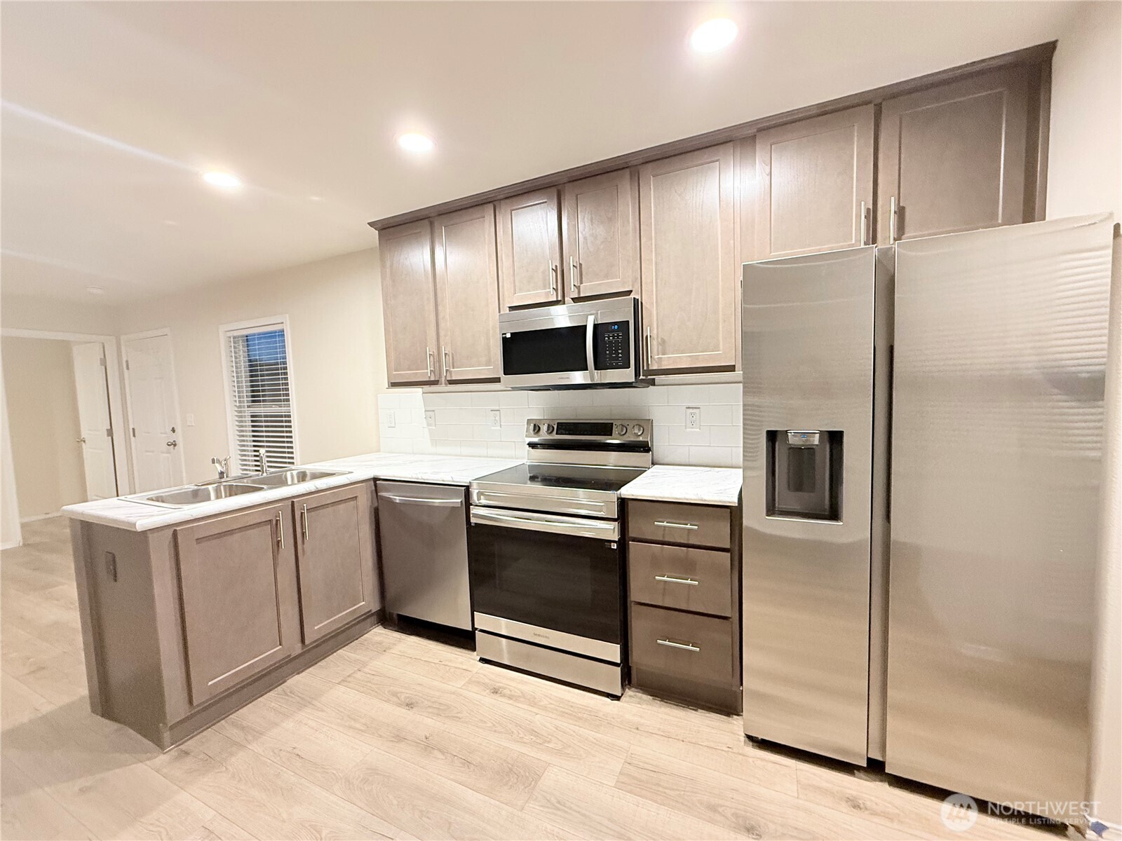 2322 Tacoma Road East, Unit 11 Puyallup, WA 98371 - Photo 3 of 15 a kitchen with stainless steel appliances granite countertop a refrigerator stove and sink