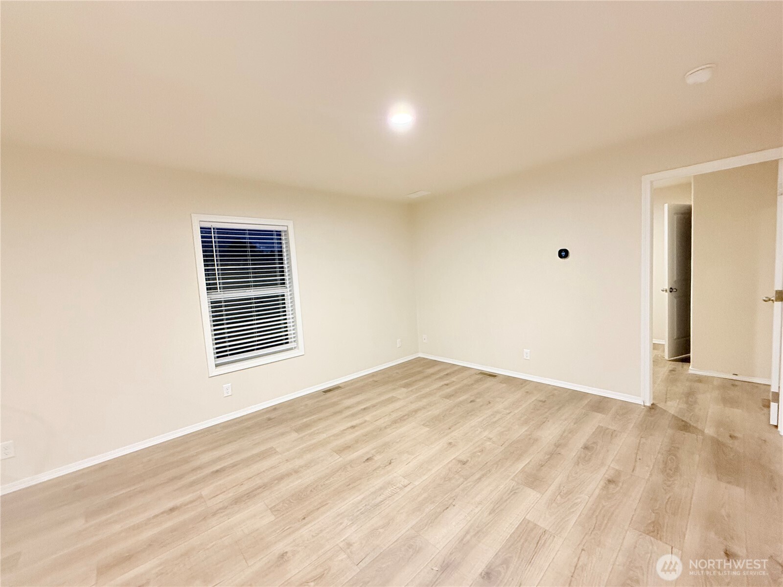 2322 Tacoma Road East, Unit 11 Puyallup, WA 98371 - Photo 6 of 15 a view of an empty room with wooden floor and a window