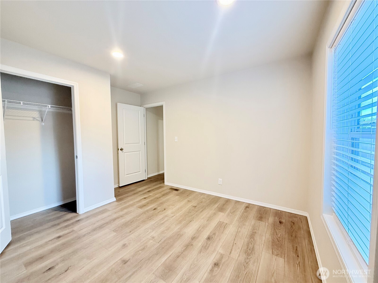 2322 Tacoma Road East, Unit 11 Puyallup, WA 98371 - Photo 8 of 15 a view of an empty room with wooden floor and a window