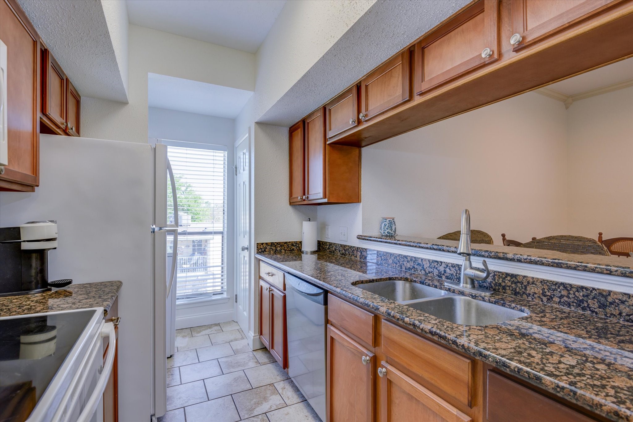4001 East NASA Parkway, Unit 222 El Lago, TX 77586 - Photo 8 of 30 a kitchen with stainless steel appliances granite countertop a sink stove and cabinets