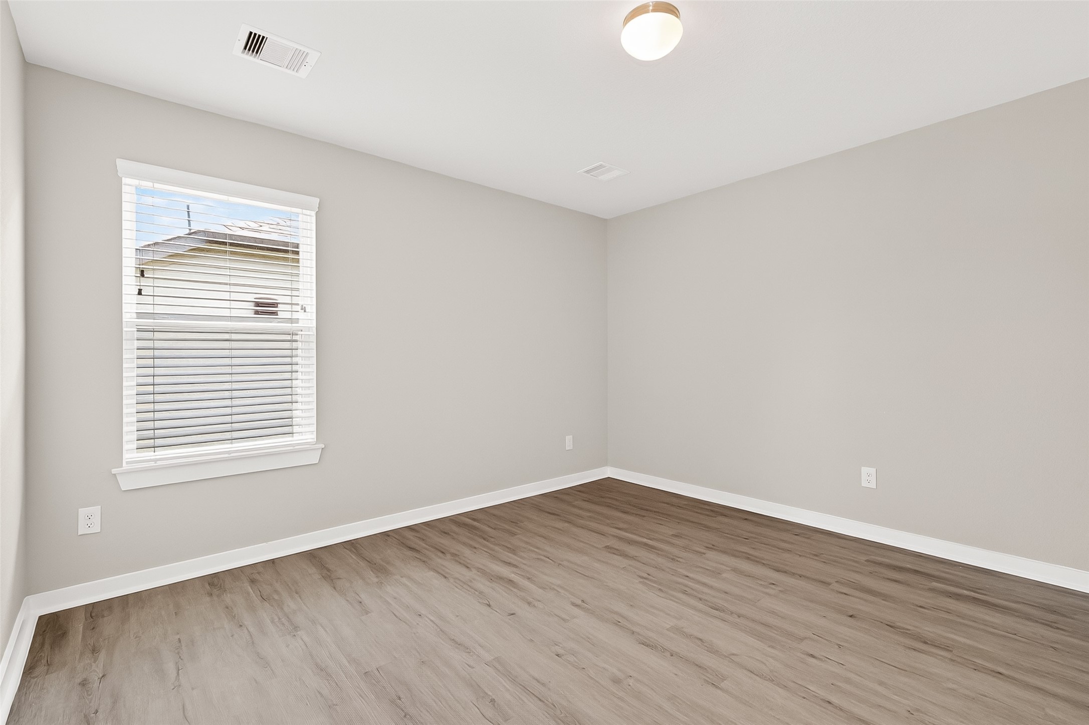 2142 Reed Cave Lane Spring, TX 77386 - Photo 39 of 50 a view of an empty room with wooden floor and a window